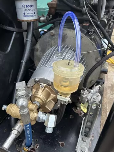 Refurbished Nilfisk C3 pressure washer pump installed alongside unloader valve during industrial diesel hot pressure washer repair in Dover.